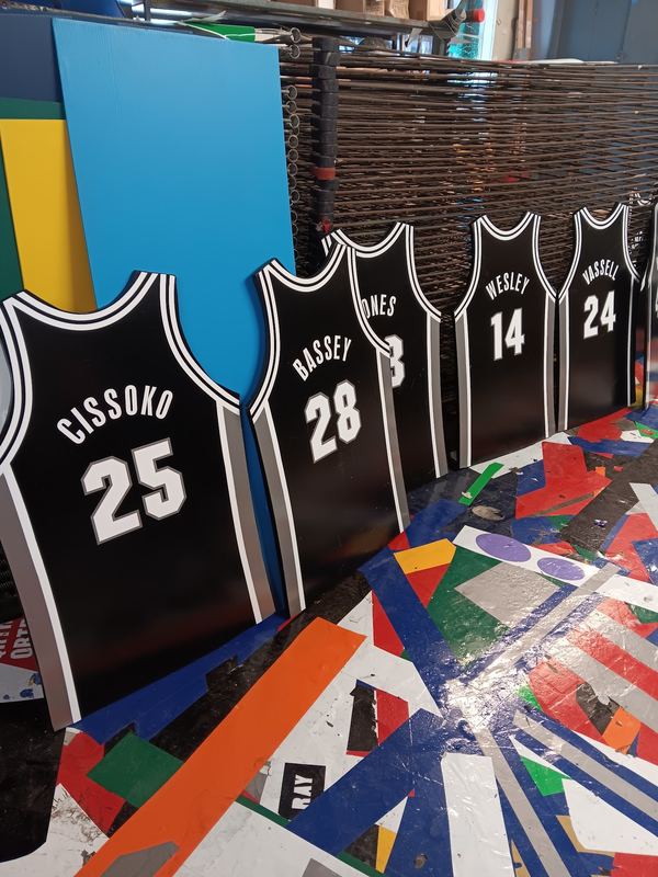 Custom screen printed basketball jerseys drying in the shop