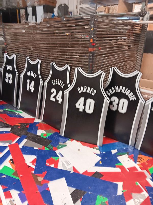 Custom numbered team uniforms laid out after screen printing