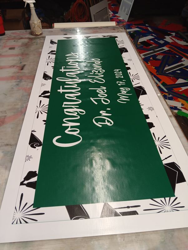 Large green vinyl congratulations banner printed for a graduation