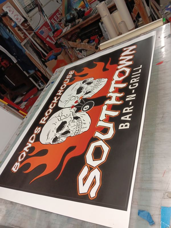 Custom painted wood sign for a bar and grill with flame artwork