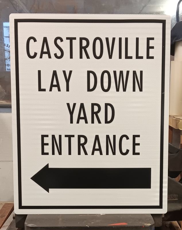 Directional wayfinding sign with an arrow to the yard entrance