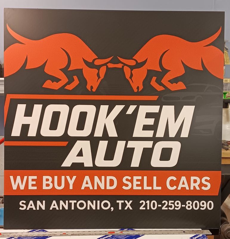 Metal business sign for an auto dealership with logo artwork