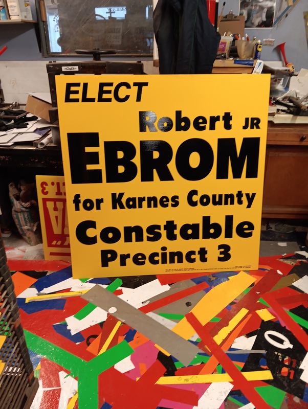 Yellow political campaign yard sign for a constable candidate