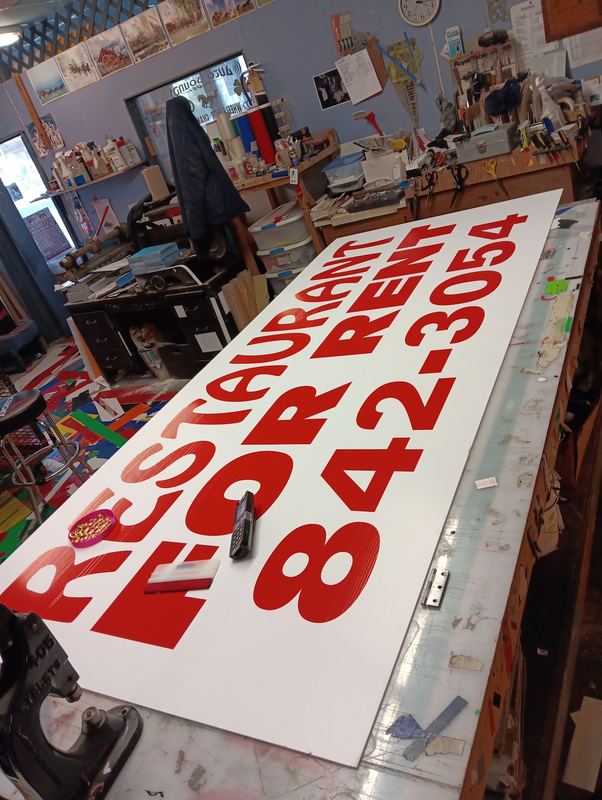 Large red and white restaurant for rent property sign