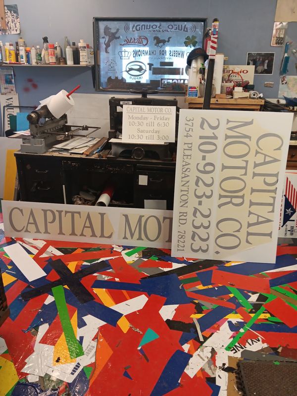 Interior workbench of the Rayco sign shop with tools and finished signs