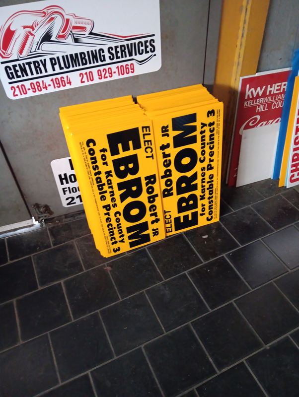 Stack of printed political campaign yard signs ready for delivery