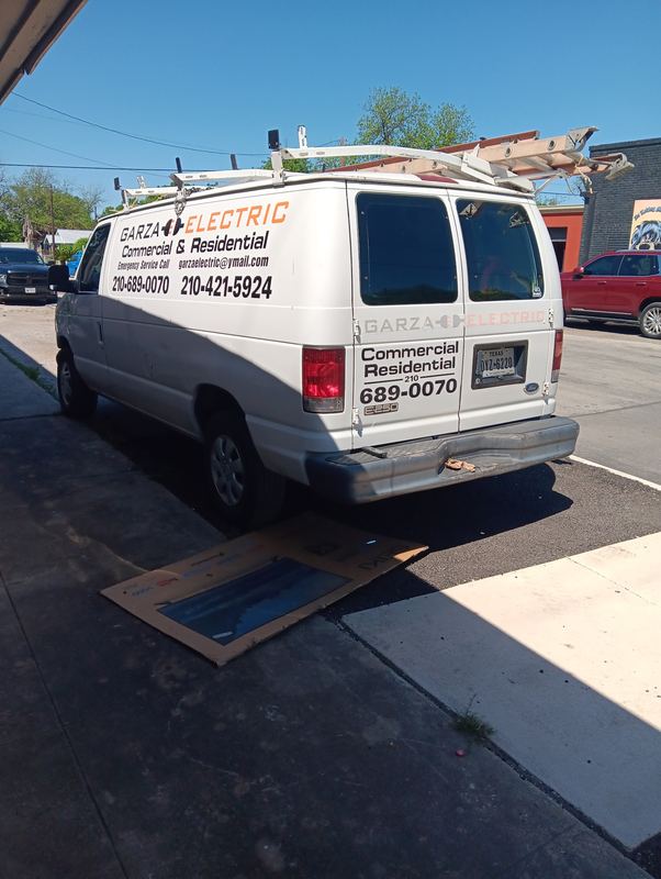 Electrical contractor work van with vinyl lettering and phone number